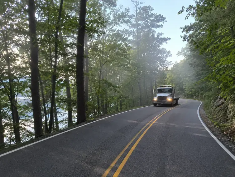 Tow truck on a wooded road near Lake Houston in the Atascocita area